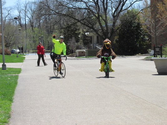 Dr. Ski on his bike riding through campus