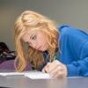 girl working on paper at desk